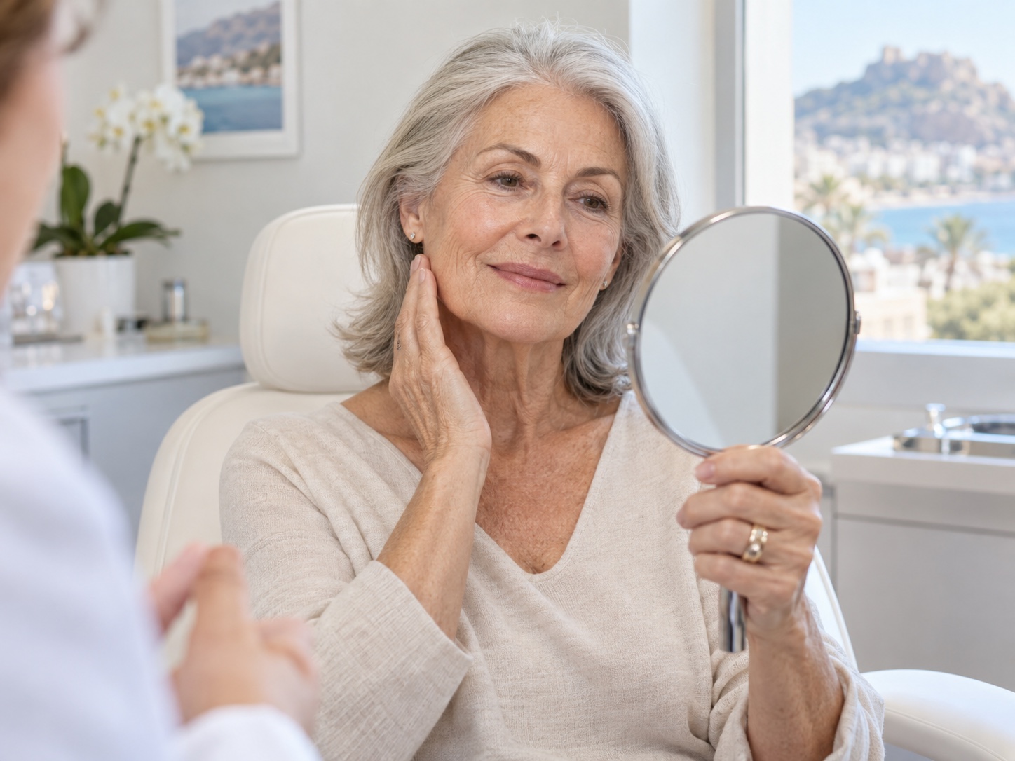 Mature woman discussing facial fat transfer during a consultation in Alicante
